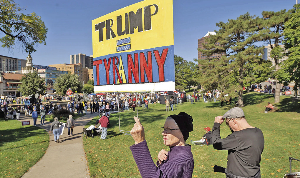 Stephanie Bradt, at left, and her brother Clint Bradt near the crowd gathered at a No Kings rally that drew thousands of people to Mill Creek Park east of the Country Club Plaza (Julie Denesha/KCUR)