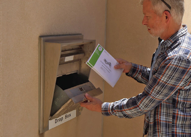 (Right) Greg Lange of Bismarck, North Dakota, drops off his absentee ballot and his wife’s at the Bismarck Burleigh County Office Building. (Photo by Michael Achterling/North Dakota Monitor)