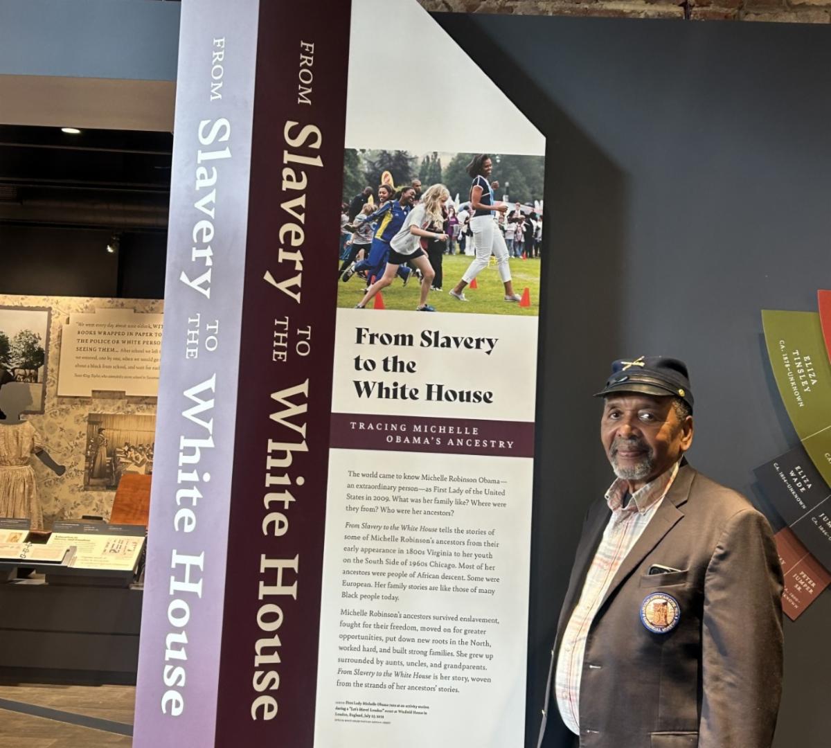 Dr. Frank Smith, founder and executive director of the African American Civil War Museum, stands at the entrance of the museum where a new exhibit on the life of former First Lady Michelle Obama is on display. The First Lady is the descendant of two members of the United States Colored Troops Who fought in the Civil War. The exhibit officially opened Sept. 30 during a reopening ceremony of the Museum. (Photo credit: hazel Trice Edney/Trice Edney  Newz
