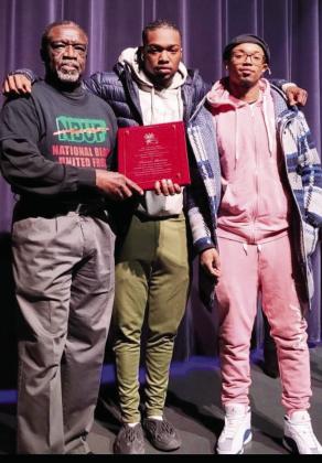 Mickey Dean of NBUF-KC presents the 2022 Charles Miller Black Liberation Award to Tenesia Brown, CEO of Keys Realty. Accepting the award are her sons: Jakobi Sanders (left) and Michael Sanders, Jr.