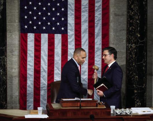 Minority Leader Hakeem Jeffries hands the gavel to newly elected Speaker of the House Mike Johnson on Oct. 25, 2023. photo/Chip Somodevilla/ Getty Images