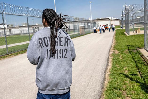 Men exercise in the maximum security yard of the Lansing Correctional Facility in Lansing, Kan. The prison population in Kansas rose nearly 5% between 2022 and 2023 (John Moore/Getty Images)