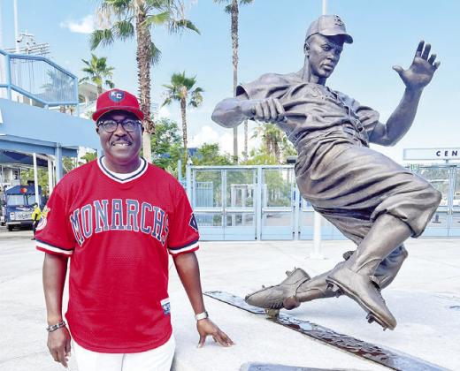 Negro Leagues Baseball Museum President/CEO Bob Kendrick on Wednesday poses in front of the Jackie Robinson statue outside Dodgers Stadium. ( Photo/Facebook)