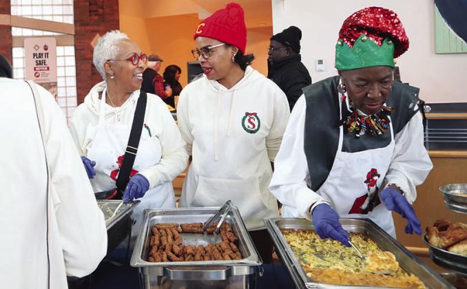 The Prospect KC Executive Director Shanita McAfee- Bryant chats with a volunteer serving breakfast at The Soul of Santa event. Photo/The Prospect KC