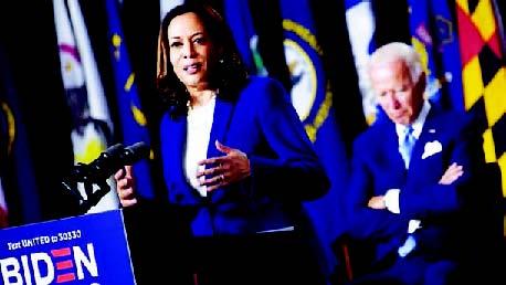 Democratic presidential nominee and former US Vice President Joe Biden listen to his vice presidential running mate, US Senator Kamala Harris, speak during their first press conference together in Wilmington, Delaware, on August 12, 2020. Olivier Douliery | AFP | Getty Images