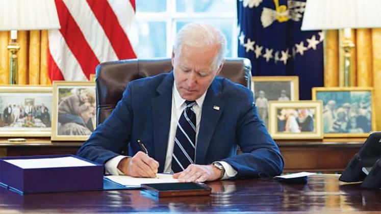 President Joe Biden today (Thursday) signs the American Rescue Plan into law in the Oval office at the White House. courtesy photo
