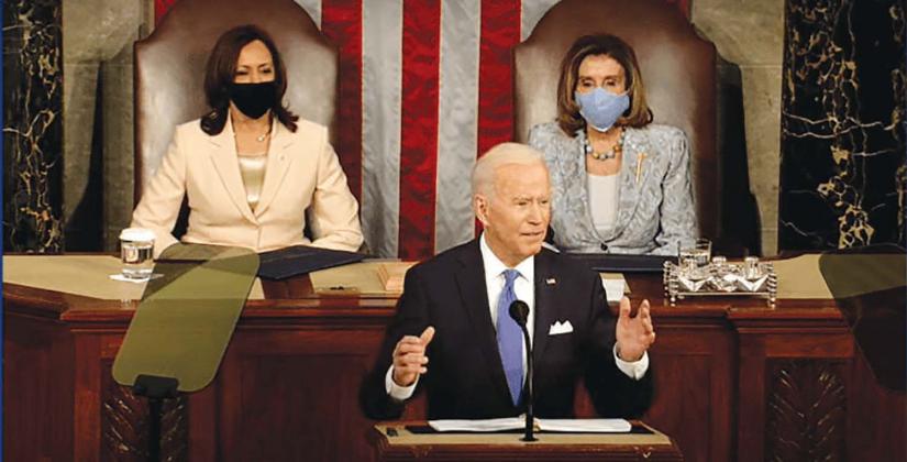 President Biden addresses Congress as Vice President Kamala Harris (l) and Madam Speaker Nancy Pelosi made history as the first women behind a president. photo/ screenshot