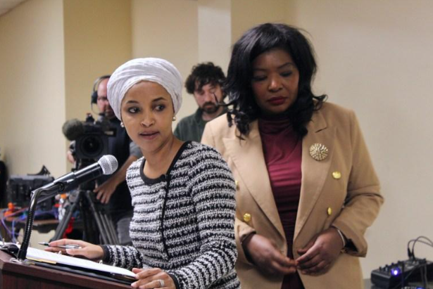 U.S. Rep. Ilhan Omar addresses attendees after being sprayed with an orange substance from a syringe during a town hall meeting in north Minneapolis on Jan. 27. She continued the event following the incident.Credit: Izzy Canizares/MSR
