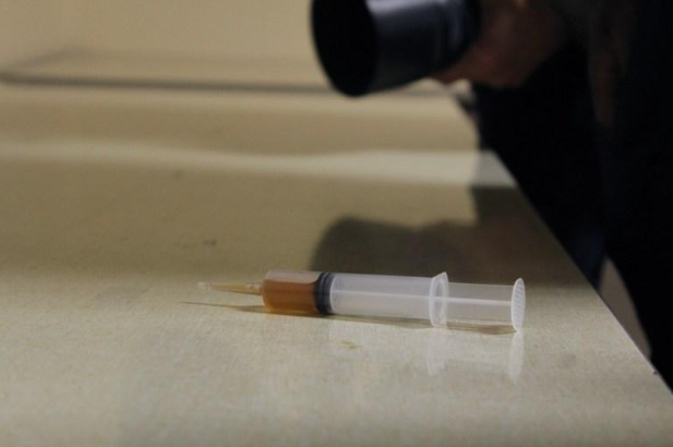 A syringe containing an orange-colored substance is shown after an individual used it to spray U.S. Rep. Ilhan Omar during a town hall meeting in north Minneapolis on Jan. 27. Police arrested a suspect at the scene. Credit: Izzy Canizares/MSR