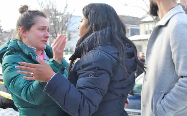 Community member being consoled by Council member Aurin Chowdhury (Courtesy Minnesota Spokesman-Recorder)