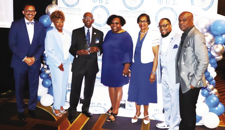 Accepting the Education Award for Dr. Tyjaun Lee (unable to attend) are some of the staff at the Metropolitan Community College, from left: Dr. Larry Rideaux, Letonia Torrence, Timothy Jones, Ella Carrol, Glennie Whitaker, Brandon Hill, Southwestern Regional Director of Phi Beta Sigma Fraternity (presenter) and John Hudson. photo/George Barrett