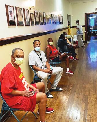 People waited patiently to get a vaccine and/or health screening.