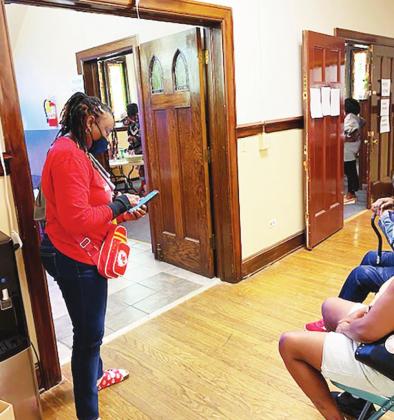 OHKCE’s Faith-Based Initiative Coordinator Leah Banks (standing) was on hand to assist.