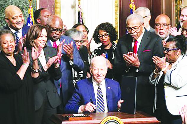 President Joe Biden signs a proclamation at the White House on July 25 designating a national monument spanning two states to memorialize Emmett Till and his mother, Mamie Till-Bradley. (photo courtesy of Mark Mahoney)-- RELATED STORY ON PAGE 8