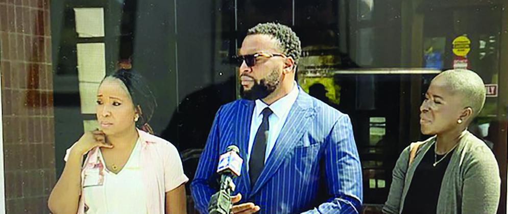 Ralph Yarl’s family’s Attorney Lee Merritt (center) in Kansas City this week, answers questions from reporters during a press conference. Others shown from left are Yarl’s mom Cleo Nabge and his aunt, Faith Spoonmore.
