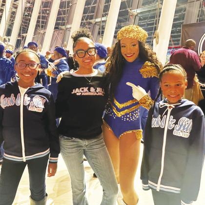 Jack and Jill members Jadyn Parson, Aniya Byrd and Jordyn Parson pose with a cast member of DRUMLine LIVE after the Feb. 8 performance at the Kauffman Center for the Performing Arts RELATED STORY, PHOTOS INSIDE, P. 3