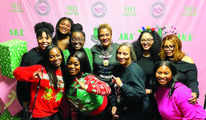Mu Omega chapter members celebrating at the Jingle &amp;amp; Mingle fundraising event