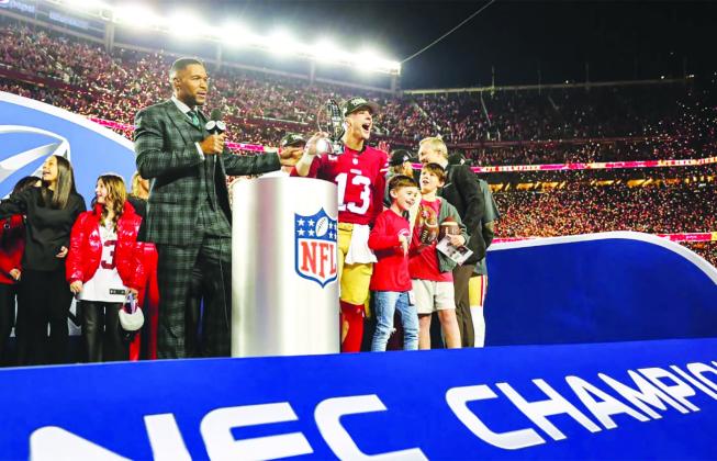 49ers QB Brock Purdy hoists the NFC Championship trophy after the postgame trophy presentation and interview following Sunday’s 34-31 win over the Lions. courtesy photo/49ers.com