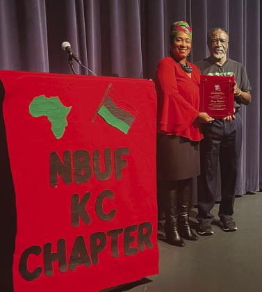 Janay Reliford receiving the Charles Miller Black Liberation Award from Mickey Dean.