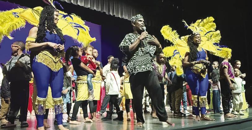 Danny Hinds with cultural group Art In Motion and students from African Centered College Prep Academy.