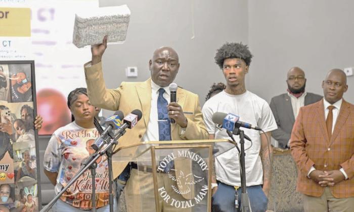Family members of baby Kohen Wiley, including his father Davion Williams, right, join Atty. Ben Crump at a press conference in Senatobia, Mississippi, on Monday, June 22. (Gary S. Whitlock/Tri-State Defender)