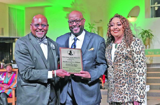 Dr. Vernon P. Howard, Jr. (left) presents the President’s Award to Pastor Eric Williams with wife Brenda