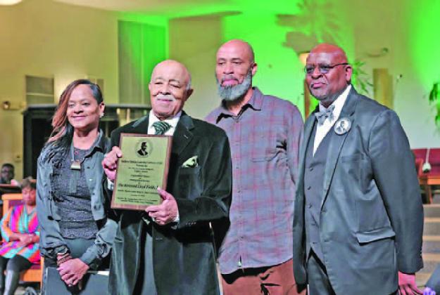 Award Recipient Rev. Lloyd Fields (holding plaque) the Rev. N. Michelle, Mr. Sean Fields, Sr.