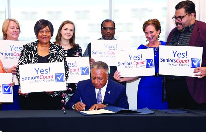 Jackson County Executive Frank White, Jr., signs the Jackson County Seniors Count ballot initiative.