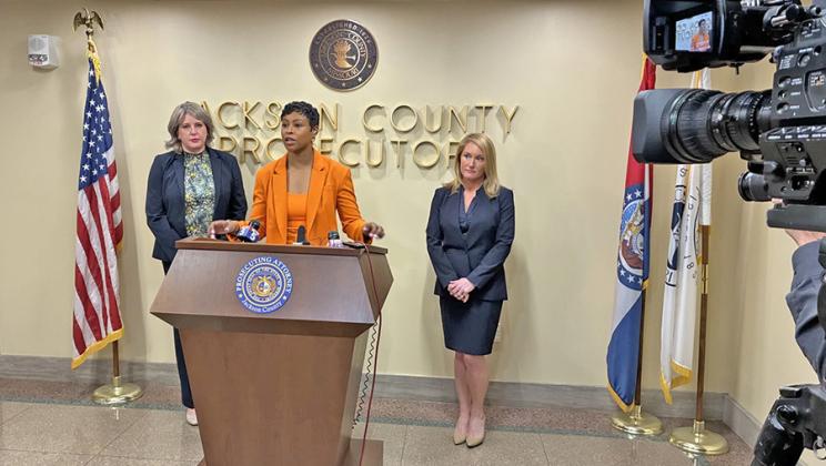 Jackson County Prosecutor Melesa Johnson talks to reporters on Tuesday, defending her office’s charging of one of the men accused in the fatal Super Bowl parade shootings in February 2024. Chief Trial Assistant Kristiane Bryant (left) and Assistant Prosecuting Attorney Hallie Schuman (right) handled the case. (Peggy Lowe/ KCUR 89.3)