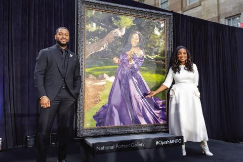 Media mogul Oprah Winfrey (right) stands beside a newly commissioned portrait of herself that unveiled at the National Portrait Gallery on Dec. 13, along with Chicago-based artist Shawn Michael Warren, who painted the portrait. (Ja’Mon Jackson/ The Washington Informer)