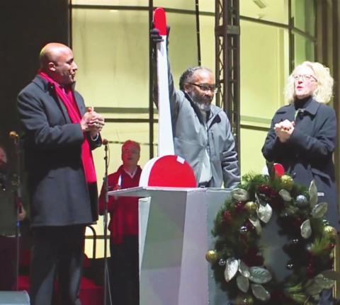 Recently exonerated Kevin Strickland (center) flips the switch to light the Mayor’s Christmas Tree, Nov. 26 as Kansas City, Missouri Mayor Quinton Lucas and others look on.
