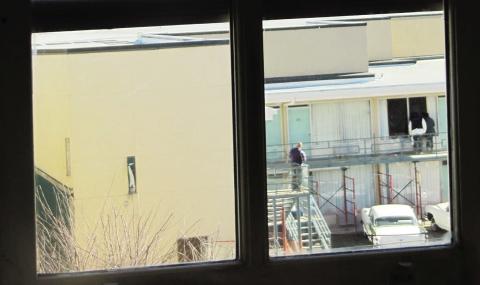 (Left) A view of Lorraine Hotel, from second floor bathroom window in the boarding house from where James Earl Ray was alleged to have fired the fatal shot at Martin Luther King, Jr. (Right) Boarding house view of Lorraine Motel balcony. Photo/Mr. Littlehand / Wikimedia Commons.