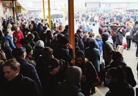 People wait for buses at a bus station as they attempt to evacuate the city on Feb. 24, 2022, in Kyiv, Ukraine. Overnight, Russia began a largescale attack on Ukraine, with explosions reported in multiple cities and far outside the restive eastern regions held by Russian-backed rebels (Photo by Pierre Crom/Getty Images).