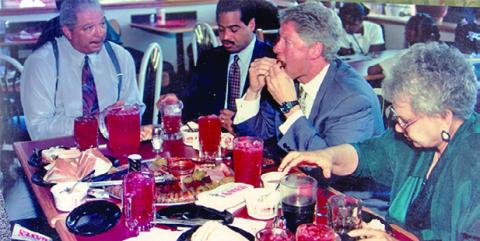 Throughout its 80-year history Gates Bar-B-Q has been a favorite of many national and world leaders and dignitaries. In this archive photo is then President Bill Clinton (second from right), Congressman Alan Wheat (second from left) and Ollie Gates (left). (Photo/gatesbbq.com)
