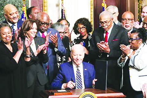 President Joe Biden signs a proclamation at the White House on July 25 designating a national monument spanning two states to memorialize Emmett Till and his mother, Mamie Till-Bradley. (photo courtesy of Mark Mahoney)-- RELATED STORY ON PAGE 8