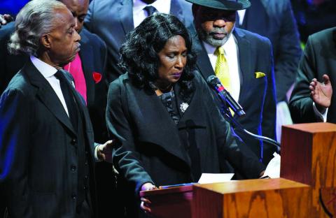 RowVaughn Wells speaks alongside her husband Rodney Wells and the Rev. Al Sharpton during the funeral service for her son Tyre Nichols at Mississippi Boulevard Christian Church in Memphis, Tenn., on Wednesday. Andrew Nelles/The Tennessean via AP, Pool