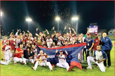 The Kansas City Monarchs baseball team and some of its management staff pose for a photo after securing the championship with a 7-6 win over the Chicago Dogs at Legends Field Wednesday night. photo/Morgan Kolenda