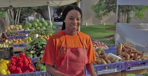 A woman at a farmer’s market. (USDA photo/Wikimedia Commons license)