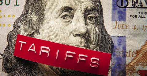 Tariffs label on a hundred dollar bill (photo via NNPA)
