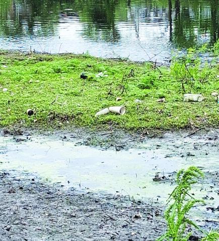 This photo shows trash and debris amid murky water in Brush Creek, east of Troost, the site of today’s faith leaders’ march and rally. Submitted photo