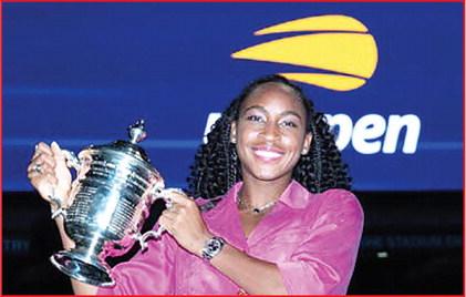 Coco Gauff hoists her trophy at the US Open celebrations. photo/© PA Images