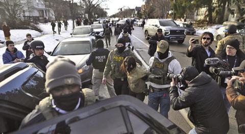 U.S. Immigration and Customs Enforcement officers detain an observer after making arrests in January in Minneapolis. Bills in more than half a dozen states would prohibit ICE agents at the polls, which is already illegal under federal law (Missouri Independent)