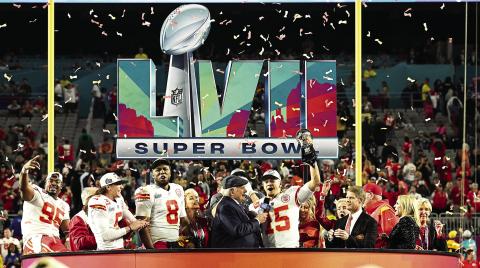 Kansas City Chiefs QB Patrick Mahomes surrounded by some of his teammates, staff and owner Clark Hunt hoists the Lombardi Trophy as he is being interviewed following Sunday’s victory over the Philadelphia Eagles at State Farm Stadium in Glendale, Ariz. photo courtesy, kcchiefs