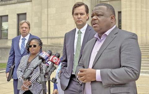 Erica Adair, Charles Adair's sister, and lawyers representing his family speak outside the Wyandotte County courthouse Wednesday after viewing body camera footage of the moments leading up to his death for the first time. (Jodi Fortino/KCUR 89.3)