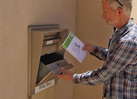 (Right) Greg Lange of Bismarck, North Dakota, drops off his absentee ballot and his wife’s at the Bismarck Burleigh County Office Building. (Photo by Michael Achterling/North Dakota Monitor)