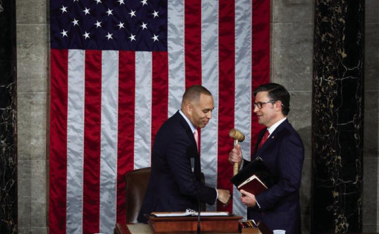 Minority Leader Hakeem Jeffries hands the gavel to newly elected Speaker of the House Mike Johnson on Oct. 25, 2023. photo/Chip Somodevilla/ Getty Images