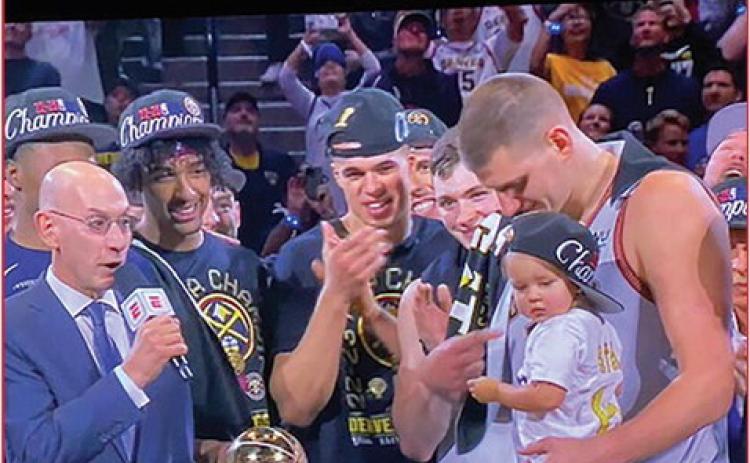 NBA Commissioner Adam Silver presents the NBA Finals MVP Award to Nikola Jokic, holding his daughter and flanked by team members including Mizzou alum Michael Porter (center) and KU alum Christian Braun (center, right). photo/screenshot