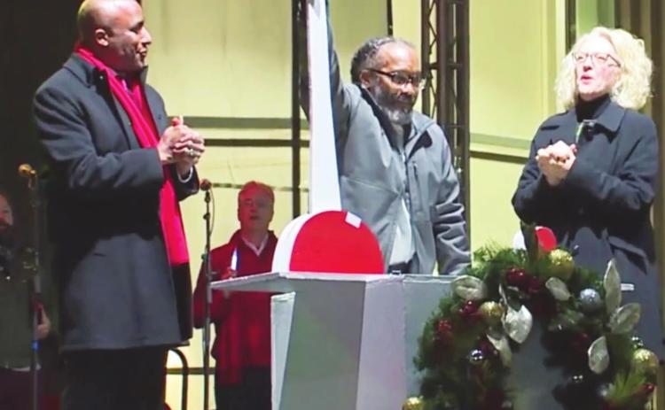 Recently exonerated Kevin Strickland (center) flips the switch to light the Mayor’s Christmas Tree, Nov. 26 as Kansas City, Missouri Mayor Quinton Lucas and others look on.