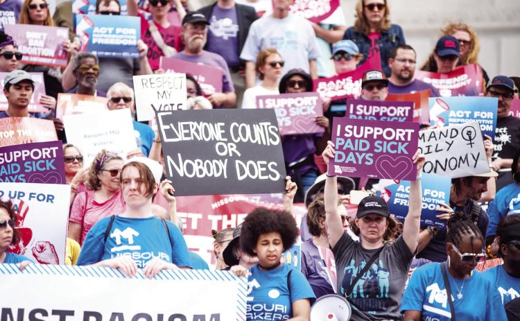 Protestors hold up signs criticizing Missouri lawmakers’ recent votes to overturn ballot measures passed in 2024 during a rally on the Missouri Capitol steps Thursday (Annelise Hanshaw/Missouri Independent).