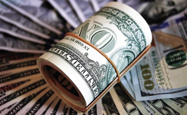 (Left photo): The Kansas Department of Revenue said state tax collections of $704 million in October exceeded expectations by 11% or $73 million. It was the 27th consecutive month state tax revenue surpassed the forecast. (Getty Images)